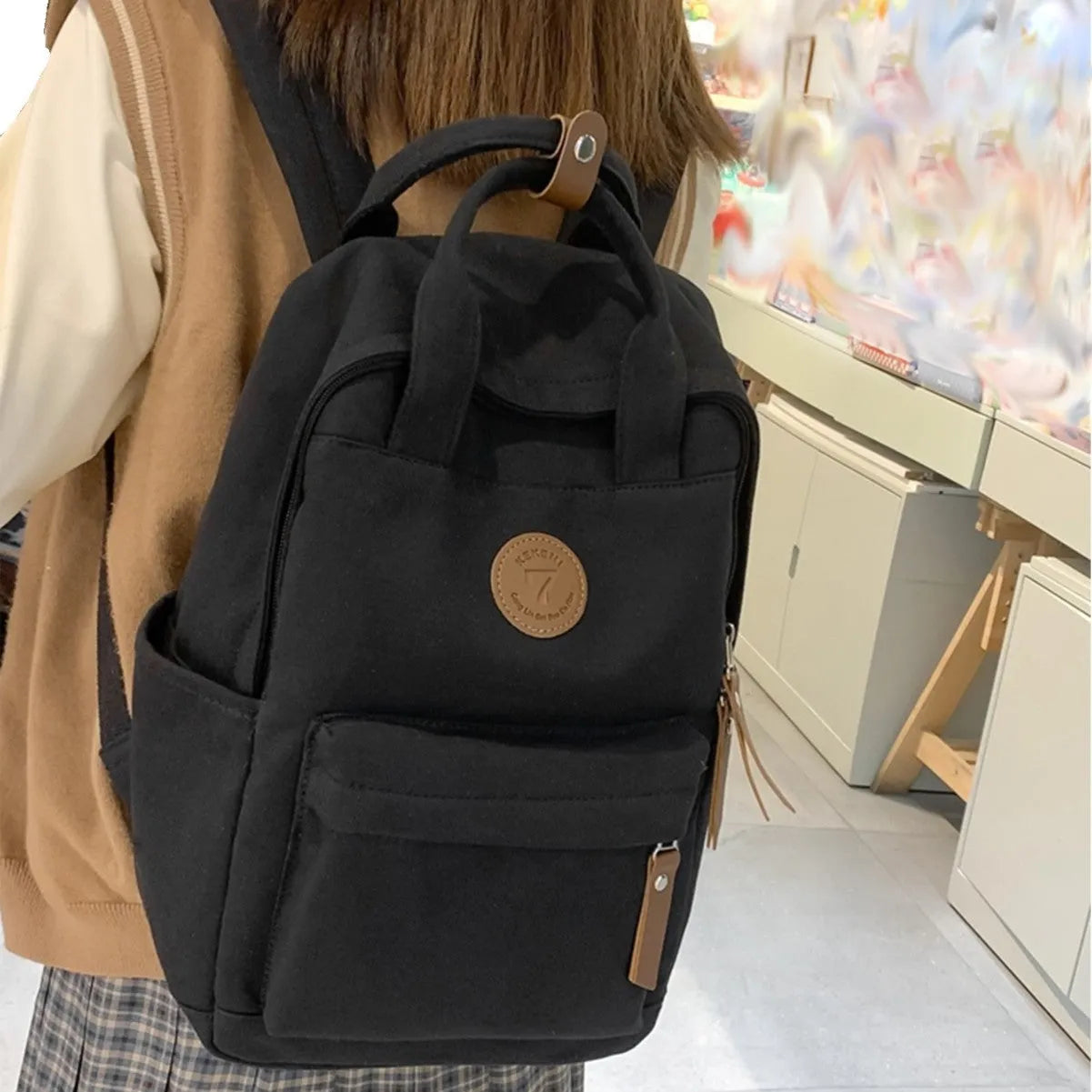 Black Oxford cloth leisure backpack with curved shoulder straps and urban simplicity styling