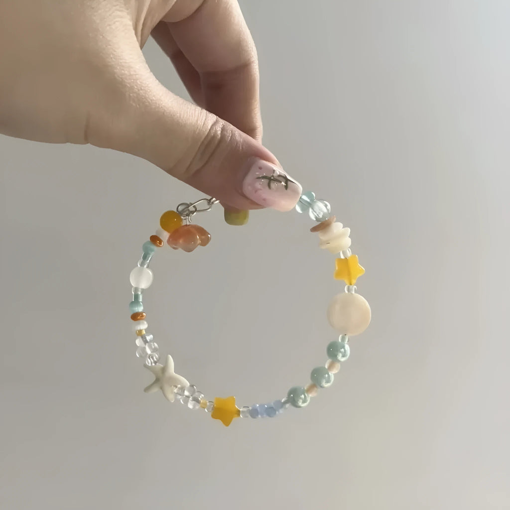 Orange diamond-shaped women's bracelet with round elements, made from mixed materials for summer seaside style.
