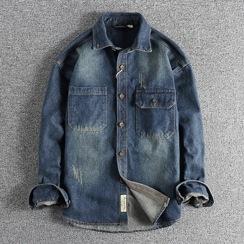 Men's light blue washed vintage denim shirt with a loose fit and long sleeves on a hanger.