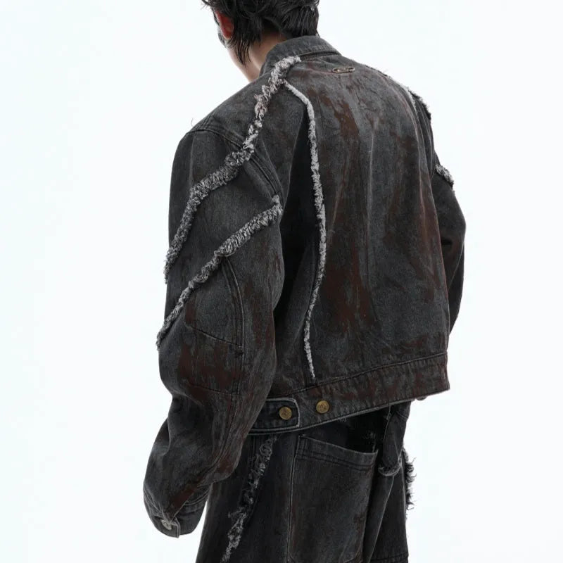 Loose fit black splash-dye distressed denim coat with padded shoulders and matching pants on model