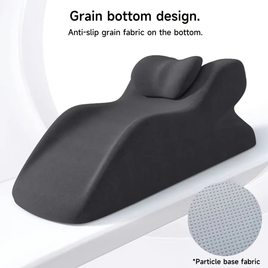 A blue stomach sleeper pillow on a bed, designed for lying face down.