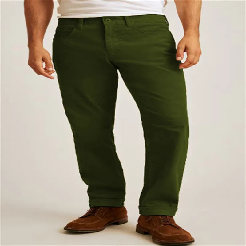 Man wearing loose fit straight-leg corduroy trousers in a solid colour.