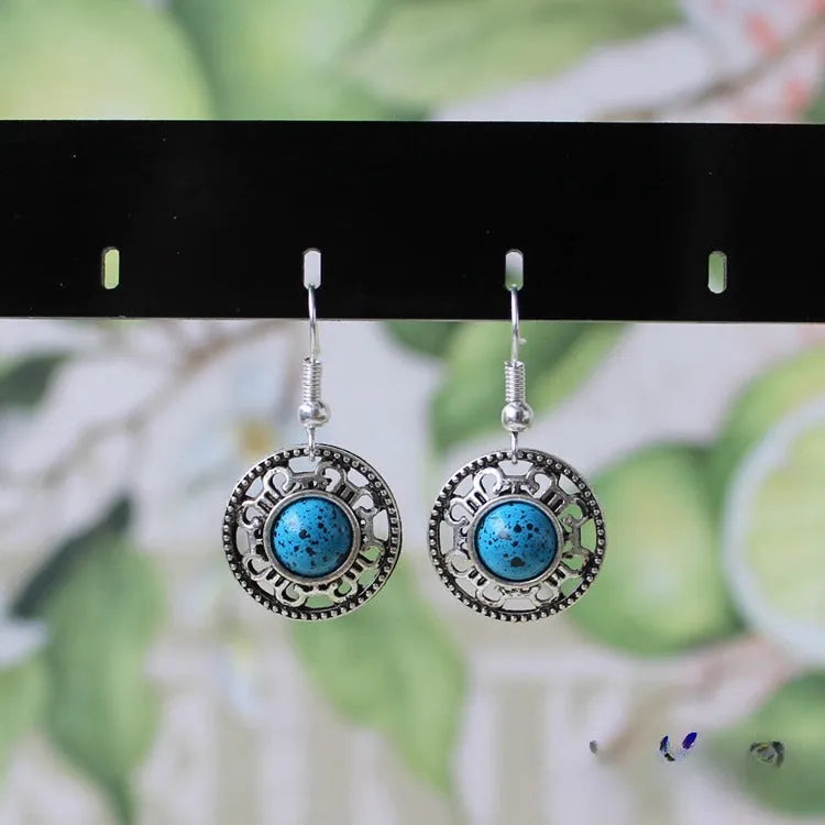 Handmade Miao silver retro earrings with turquoise inlay and geometric flower disk design