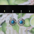 Handmade Miao silver retro earrings with turquoise inlay and geometric flower disk design