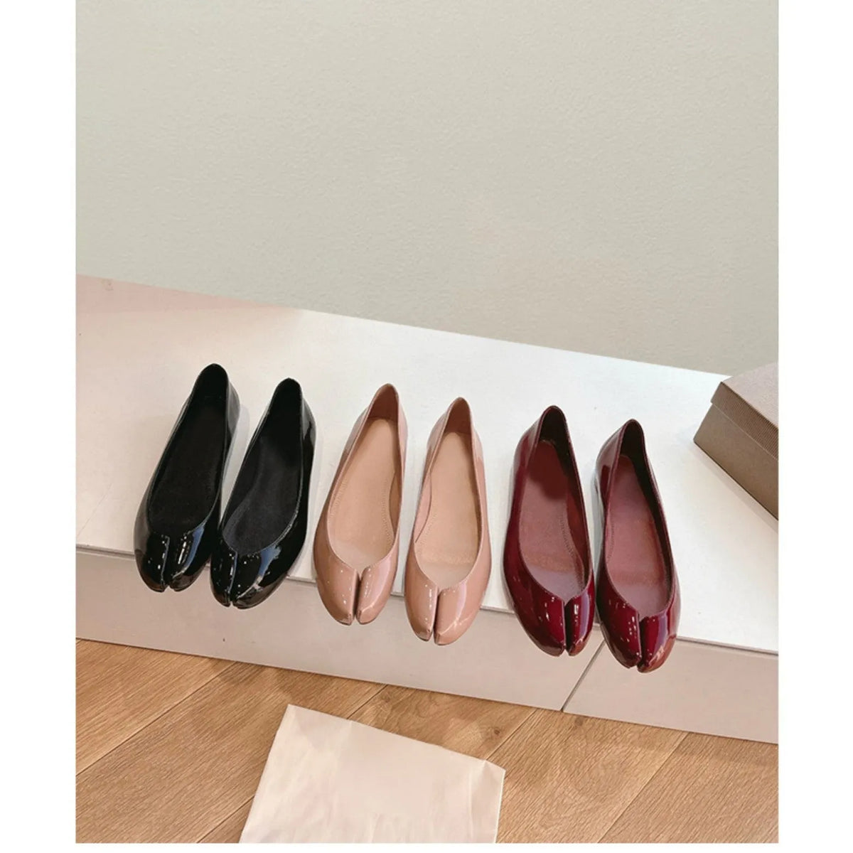 Women's slip-on flat bottom split toe pumps in red with low heel and rubber sole