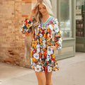 Orange floral print mini dress with V neck, long sleeves and vertical striped lace detailing
