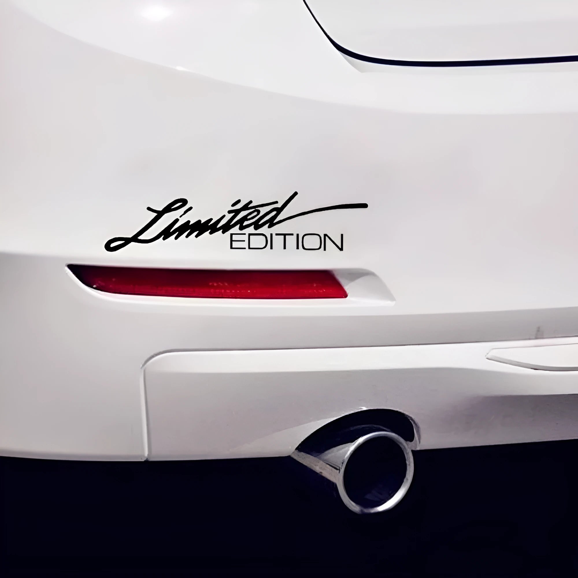 British reflective plastic bumper sticker shown in black, white and colourful variants, dimensions 16cm by 3.8cm.