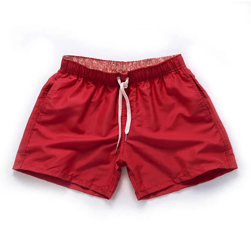 Men's straight leg beach shorts in polyester available in multiple colours and plus sizes.
