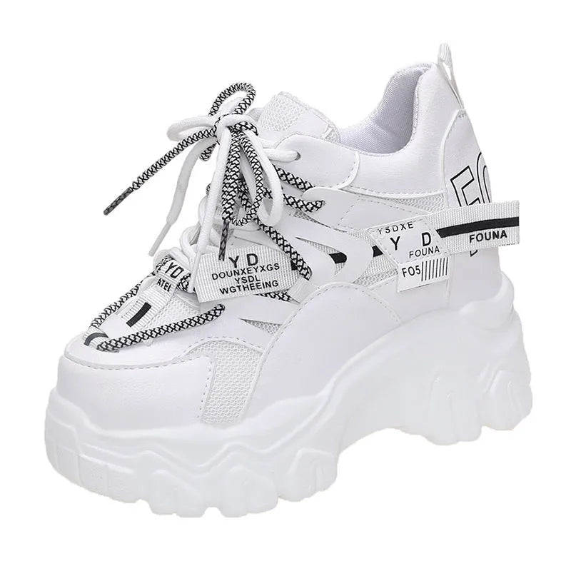 White women's low-top platform trainers with breathable mesh and a black cross-strap.