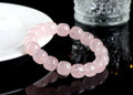 Pink barrel crystal bead bracelet with geometric design on wrist.