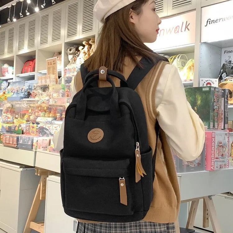 Black Oxford cloth leisure backpack with curved shoulder straps and urban simplicity styling