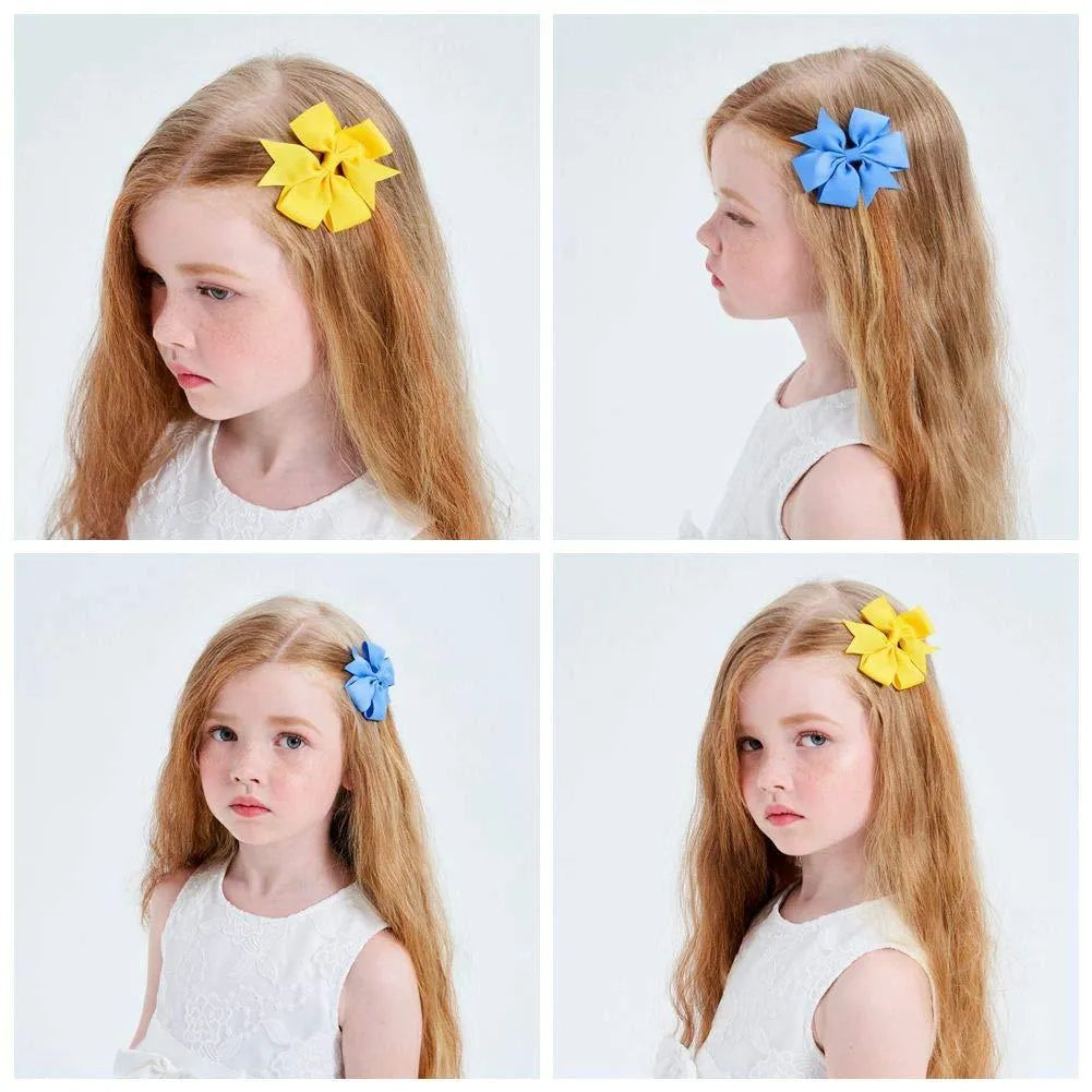 Assorted colourful 3-inch grosgrain ribbon pinwheel hair bows with alligator clips for toddlers.