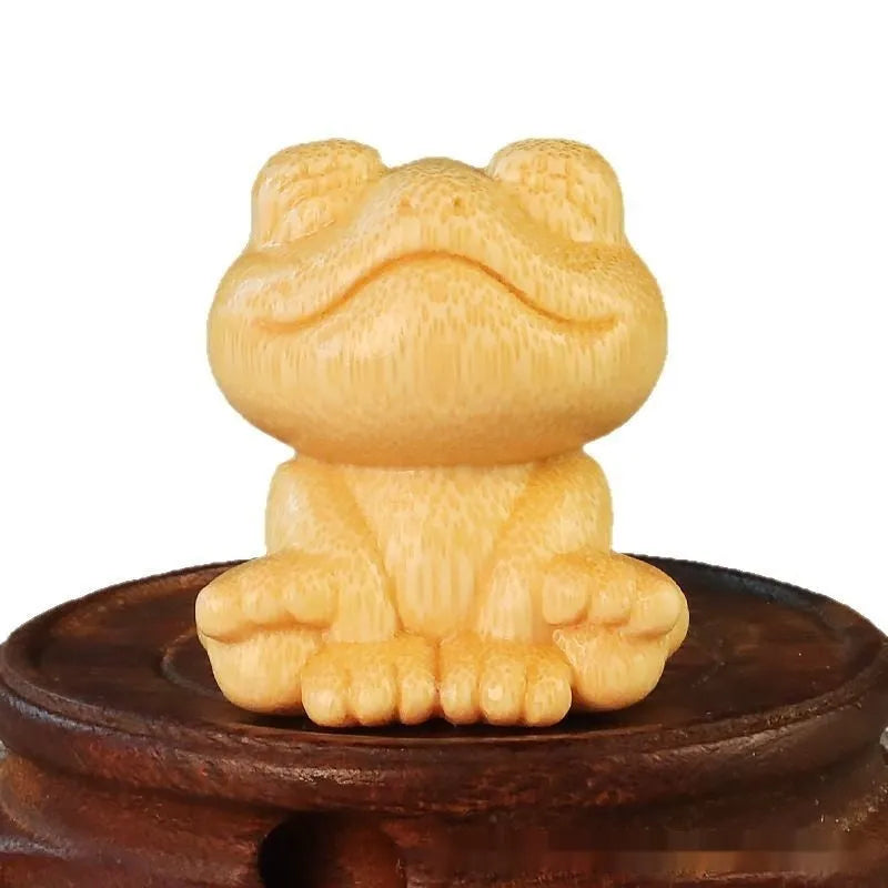 Solid bamboo smiling frog carving ornament measuring 5cm height with cartoon style design