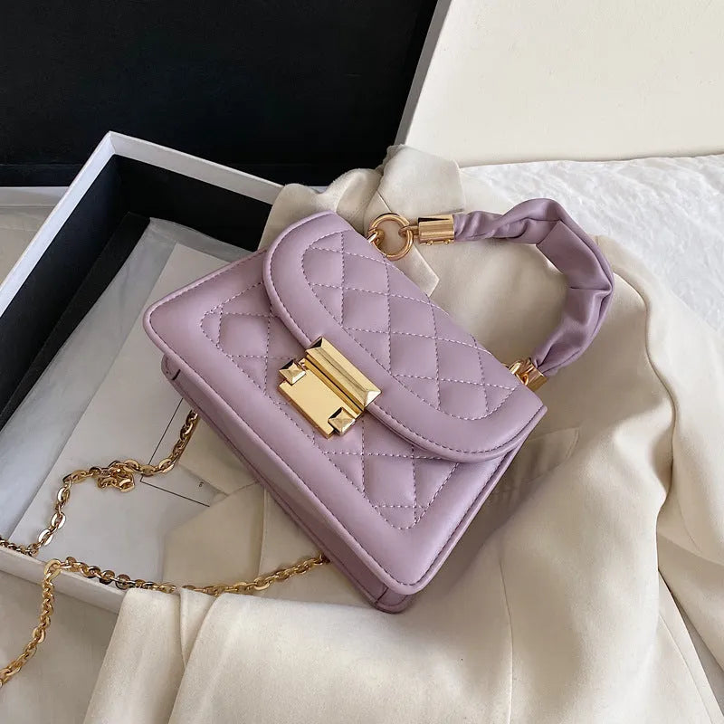 Purple rhombus square women's shoulder bag with crossbody strap on mannequin