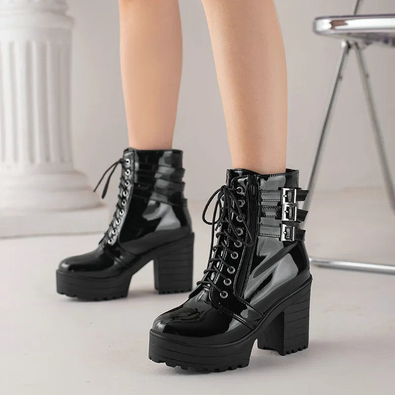 Women's black ankle boot with a thick rubber heel, round toe, and front lace-up closure on a waterproof platform.