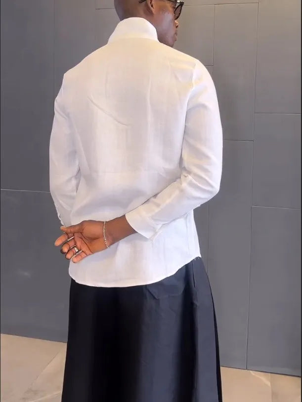 White asymmetric long sleeve shirt paired with black pleated pants in a women's casual two-piece set.
