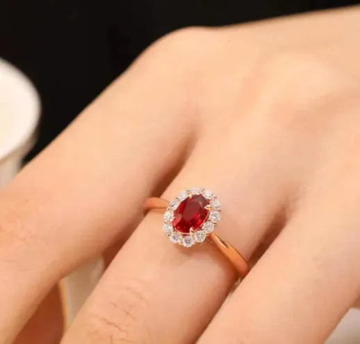 Gold Pigeon women's silver ring with red gemstone and floral gold inlaid pattern.
