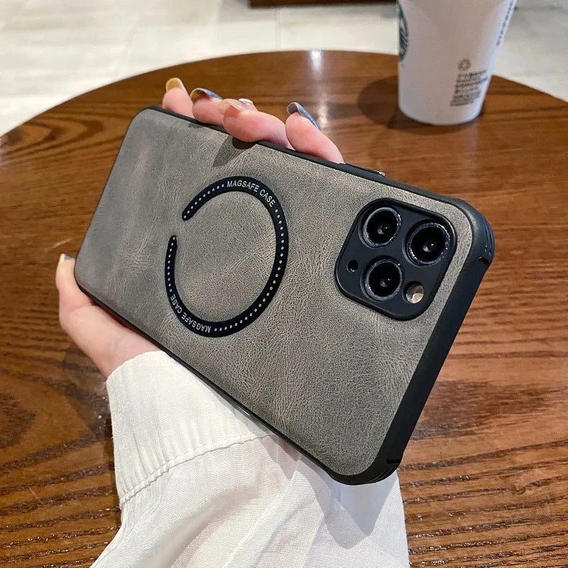 Black imitation leather magnetic charging case for Apple iPhone on a magnetic charging stand.