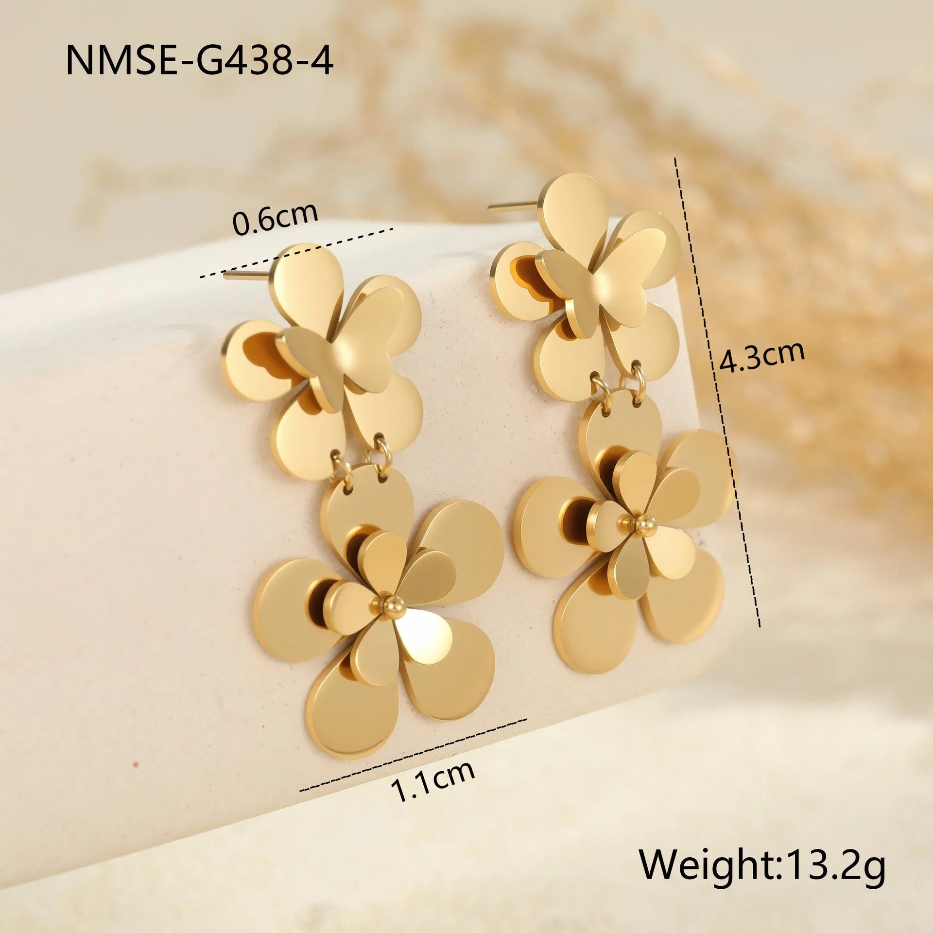 Gold-coloured flower butterfly earrings with geometric design elements on stainless steel