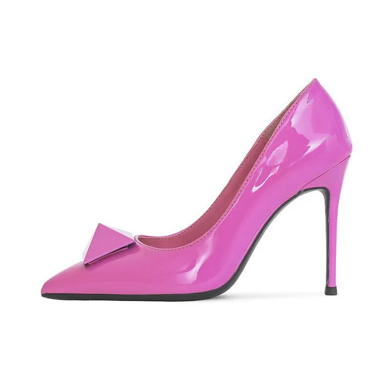 Pink pointed toe stiletto high heels with rivet detail and a buckle on the patent leather upper.