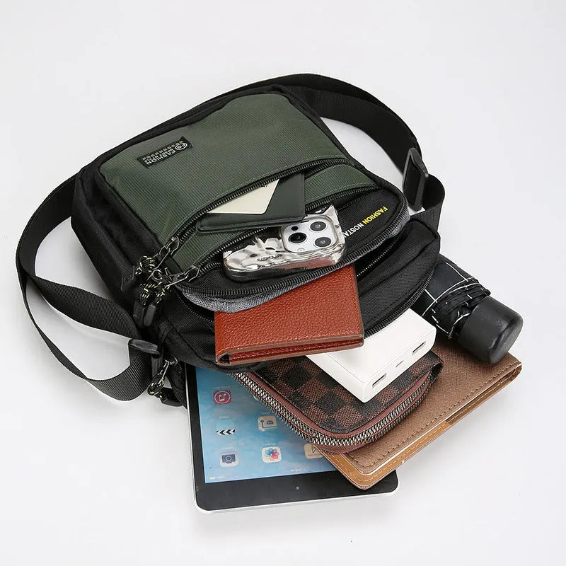 Men's nylon crossbody bag in solid colour with sewing thread detail, shown in green.