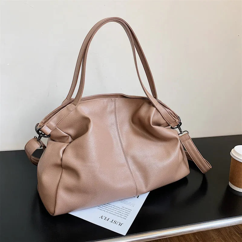 Large horizontal square soft PU messenger bag with zip and adjustable strap in four colour options.