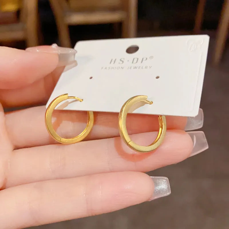 Women's geometric round ear clips with gold plating on copper in gold and silver colour options