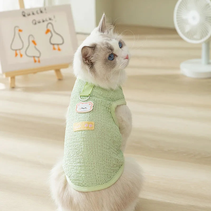 Colourful hollowed-out knitted cat clothing with a cartoon bear patch on the back