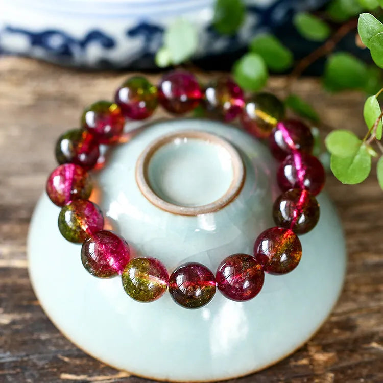 Watermelon crystal bead bracelet for women on a wrist, showing casual pastoral style.