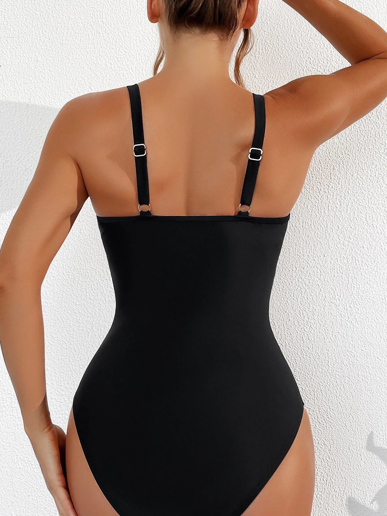 Black women's halter one-piece swimsuit with mesh detailing and sleeveless design