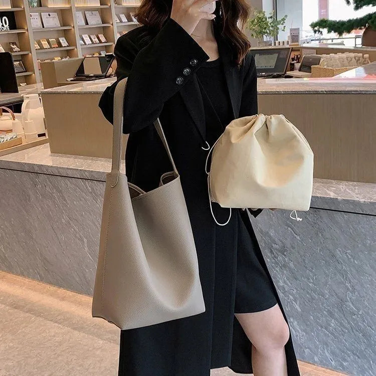 Casual PU shoulder bag for women with visible sewing thread detail in black