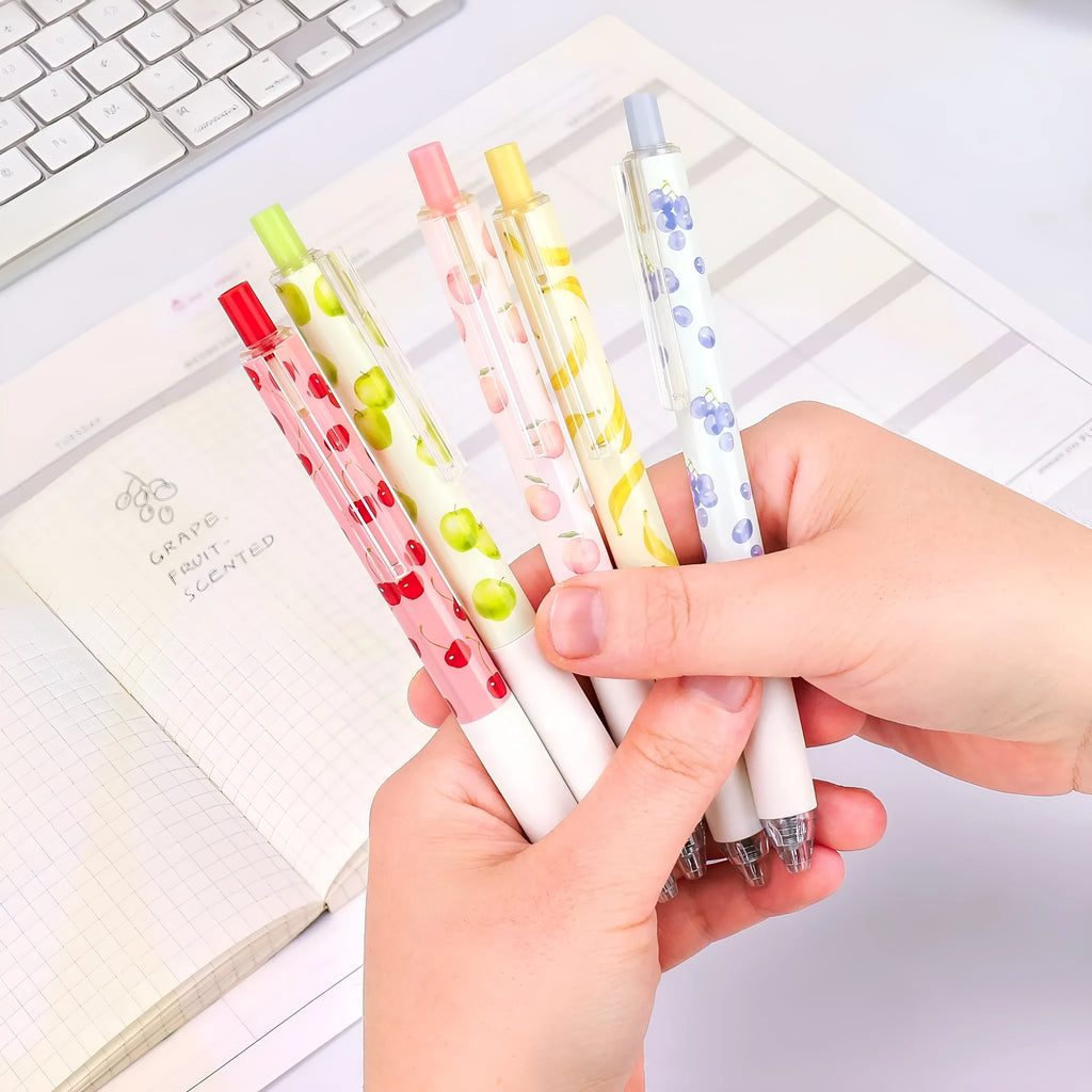 Three fruit-scented pressurised pens with push-button mechanisms and 0.5mm black refills