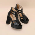 A pair of black platform high heel sandals with a back zipper and round toe on a rubber sole.