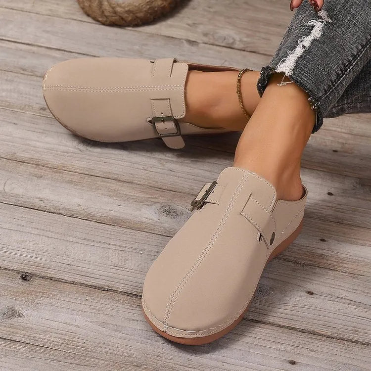 Women's casual wedge slipper in light brown with cloth upper and rubber sole.