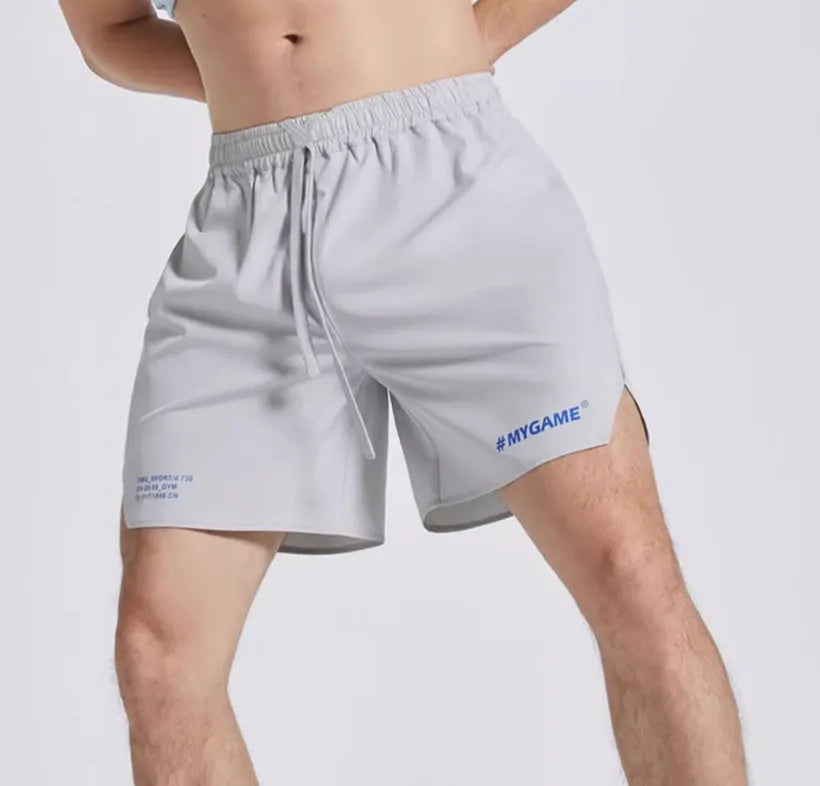 Men's four-point training shorts in a polyester blend for fitness and sports, shown in blue, black, grey, or white.