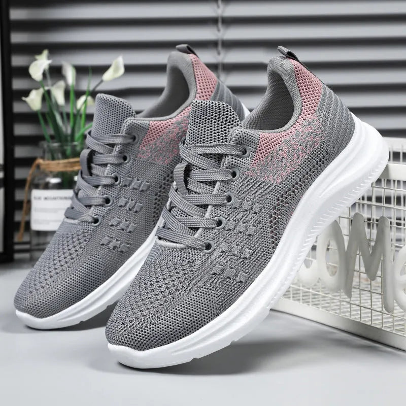 Women's black mesh sneakers with round toe and front lace-up design on soft PVC sole
