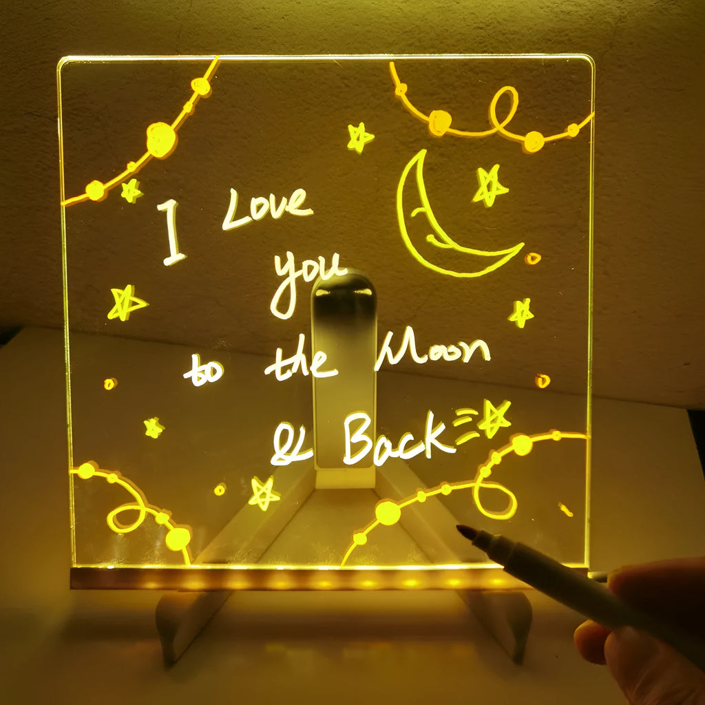 Acrylic DIY note board LED night light with USB cable, bracket, and colourful pens on a desk
