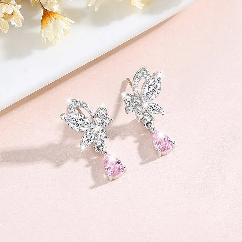 A pair of silver stud earrings with a faceted crystal butterfly design on a post backing.