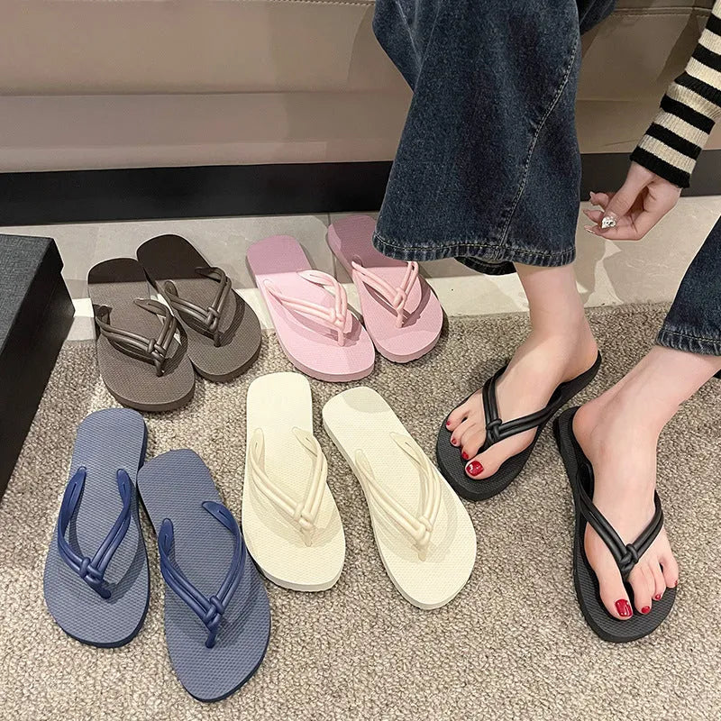 Men's PVC toe-covering flip flops on a solid colour background, showing the non-slip sole and range of available colours.