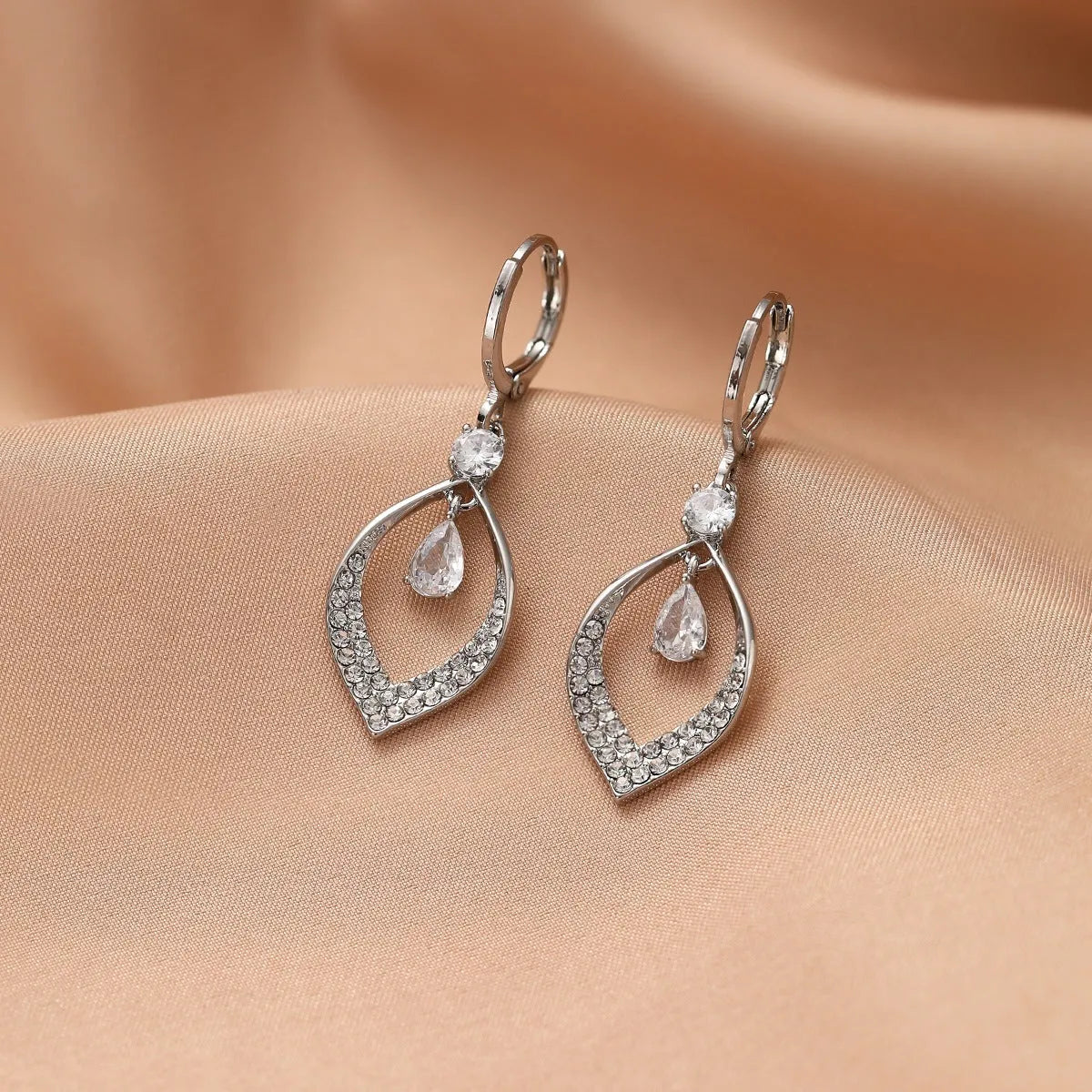 A pair of women's zircon water drop tassel earrings in a teardrop shape with gold-coloured buckles.