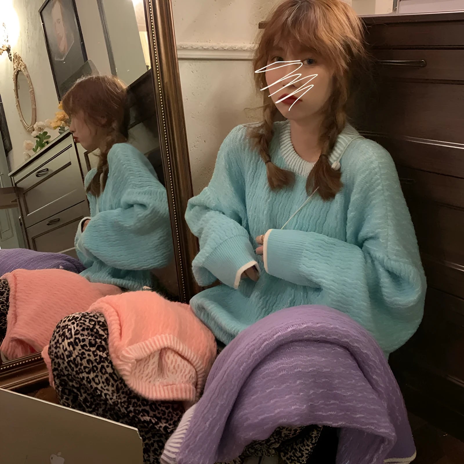 A lake blue loose-fitting women's retro pullover sweater with long sleeves on a hanger.