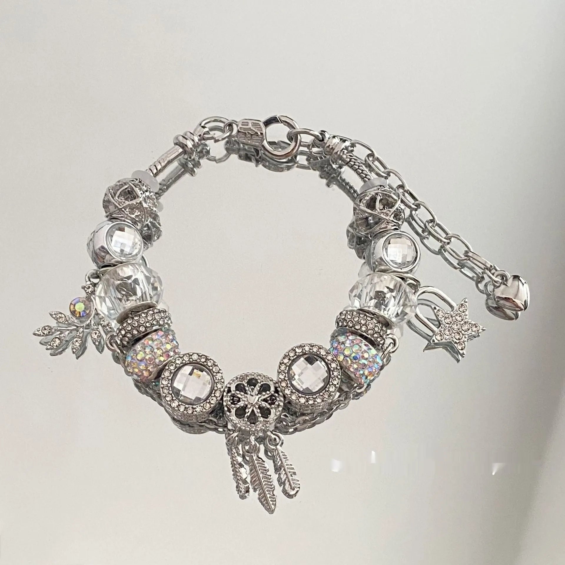 Women's dream catcher star bracelet with colourful crystals and electroplated finish on a white background