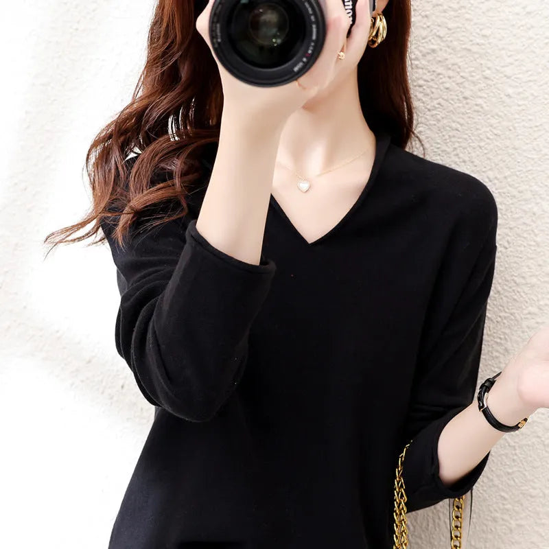 Women's grey V-neck long sleeve knitwear pullover on a hanger