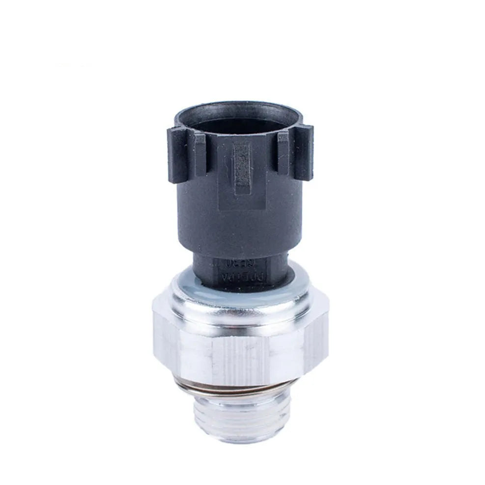 Silver automobile fuel pressure sensor replacement part on a white background.