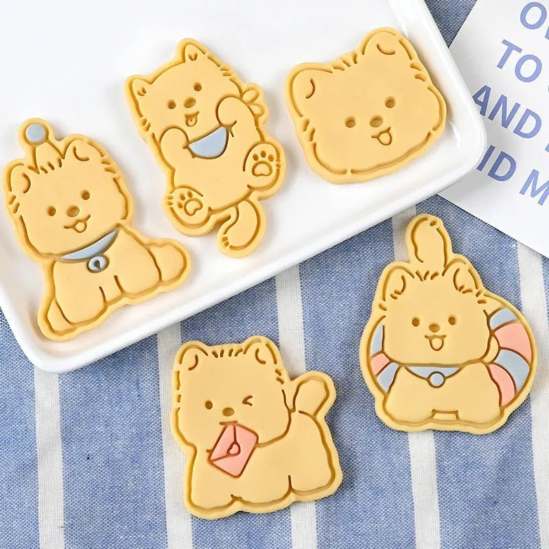 Three dimensional plastic press mould for creating puppy cartoon biscuits and cake decorations.