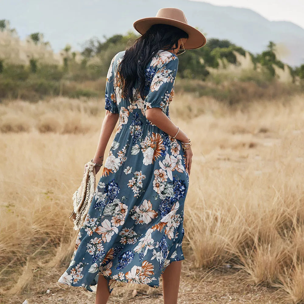 Women's yellow floral print summer dress with V neck and elastic waist on a mannequin.