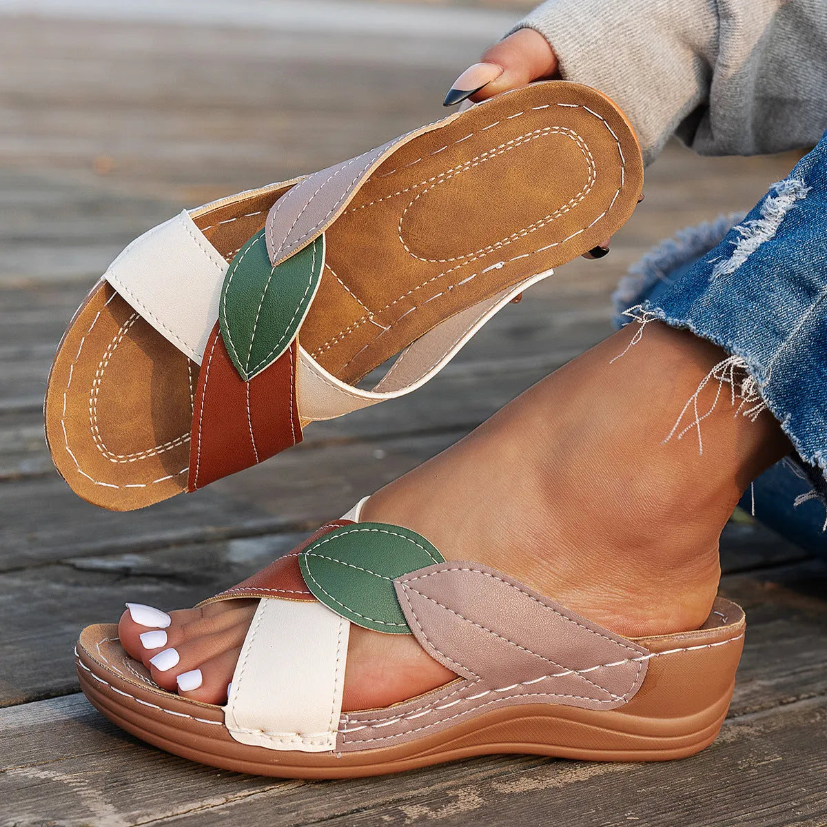 Women's black cross-strap peep-toe slippers with a thick polyurethane sole on a white background.
