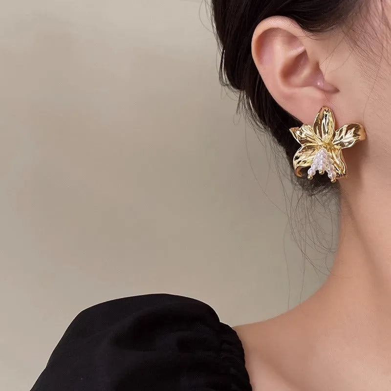 Gold floral pearl earrings with exaggerated design and Seiko-treated metal construction