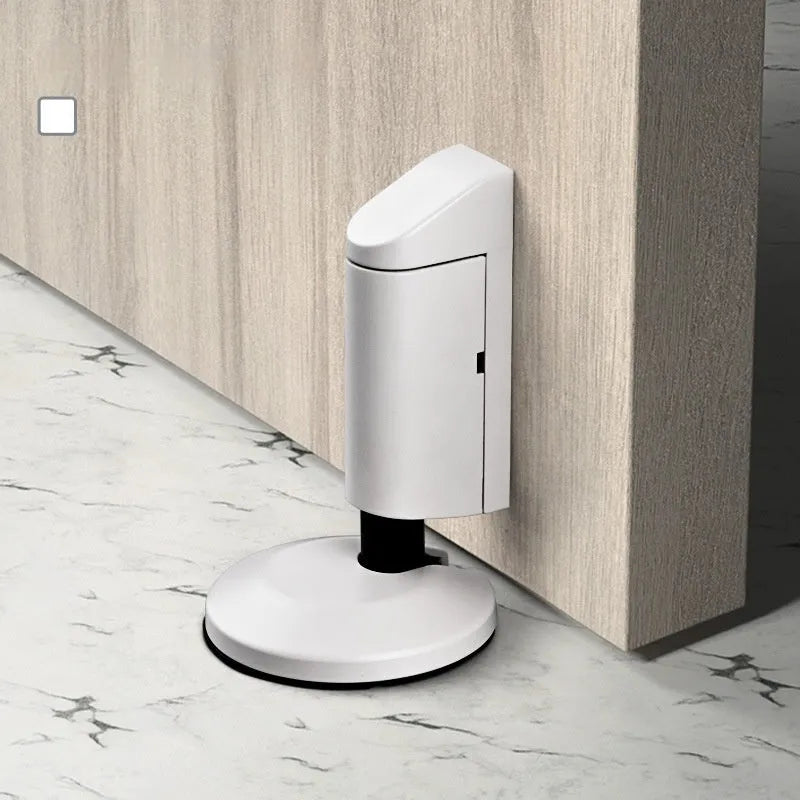 Zinc alloy invisible door stopper in a choice of six modern colour finishes on a skirting board.