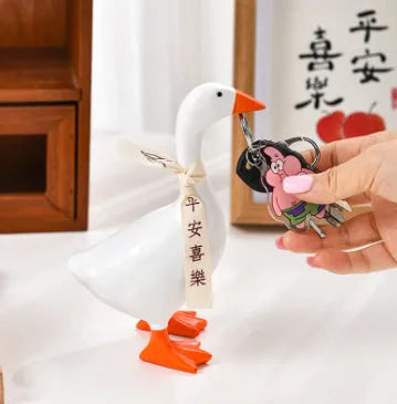 White simulated duck magnetic resin ornament on a fridge door
